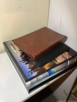 Stack of five stamp albums showing sizes and covers