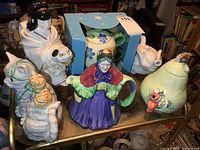 All six teapots on cart shelf