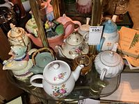 Group shot of all teapots on glass table