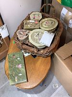Basket with six alabaster inlaid trinket boxes displayed