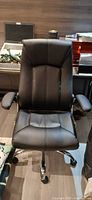 Front view of black leatherette office chair