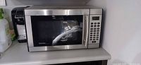 Front view of Danby stainless steel microwave on countertop