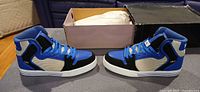 Side profile of both Supra Skytop sneakers with box