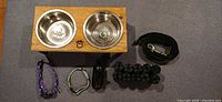 Entire lot showing bowl stand, leash, two collars, bag holder, bag rolls