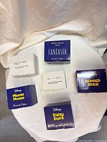 Six individual ornament boxes displayed, four blue Disney President's Edition boxes and two white outer cartons