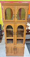 Front view of full oak veneer three-section hutch showing glass and wood doors