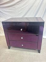 Front view showing three drawers, crystal knobs, mirrored purple finish
