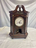 Full view of wooden mantel clock front