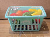 side view of mint green basket with assorted plastic food inside