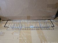 Full view of chrome bathtub caddy showing overall design and black handles