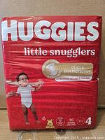 Front view of sealed Huggies Little Snugglers 70-count package