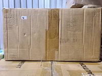 Front view of sealed cardboard shipping box for the Toshiba microwave