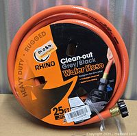 Full view of coiled Rhino 25-ft heavy duty water hose in retail packaging