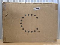 Sealed brown shipping box with Curtis Stone dotted C logo and lot sticker