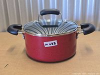 Side view of red Cook N Home pot with lid showing exterior finish and handles