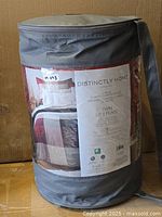 Full view of packaged comforter set with label