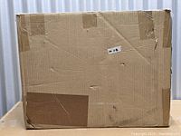 Sealed cardboard shipping box containing the dresser chest