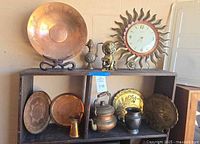 Group shot of all metal decor pieces on shelf