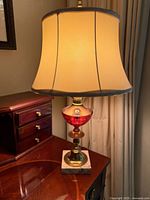 Full view of lamp with shade on wooden desk