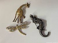 All three animal brooches grouped together