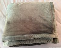 Folded gray plush blanket