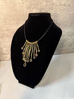 Full view of brass bib necklace on bust