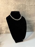 Necklace displayed on black bust showing bead graduation