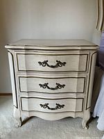 Front view showing full chest with three drawers and cabriole legs