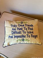 Front view showing embroidered quote and floral accents