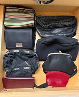 Drawer view of all eight bags and wallets