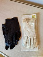 Both glove pairs side by side on table