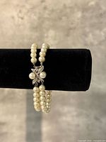 Bracelet on display bar showing double strands and clasp detail