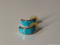 Both turquoise inlay half-hoop earrings side by side with backs attached