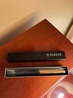 Pen inside original Parker box with plastic sleeve