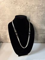 Front view of 5-strand sterling silver necklace on black bust
