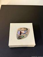 Front view of sterling silver brooch pendant showing maiden and bowl inlay