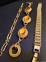 All three bracelets side by side showing designs and clasps