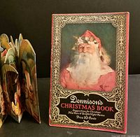 Front cover of Dennison’s Christmas Book beside folded-out manger scene