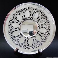 Front view of sterling silver reticulated plate showing pierced design