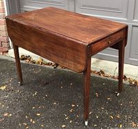 Table with leaves down showing overall form and casters