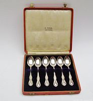 Open case showing six spoons and satin lid with H. Pearce Montreal stamp