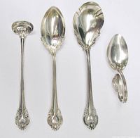 Four sterling spoons laid out front view