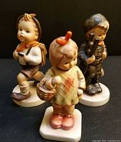 Front view of all three Hummel figurines