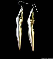 Front view of both elongated abstract figure earrings showing silver and gold wash