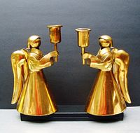 Frontal view of pair of copper angel candle holders