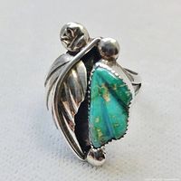 Front view showing turquoise stone, feather and beads