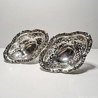 Pair of Birks sterling silver pierced bowls angled view