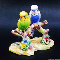 Front view of figurine showing both budgerigars and flowers