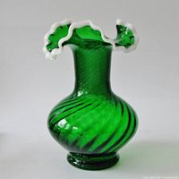 Full view showing green spiral body and white ruffled rim