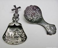 Front view of both spoons showing bowl designs and windmill finial